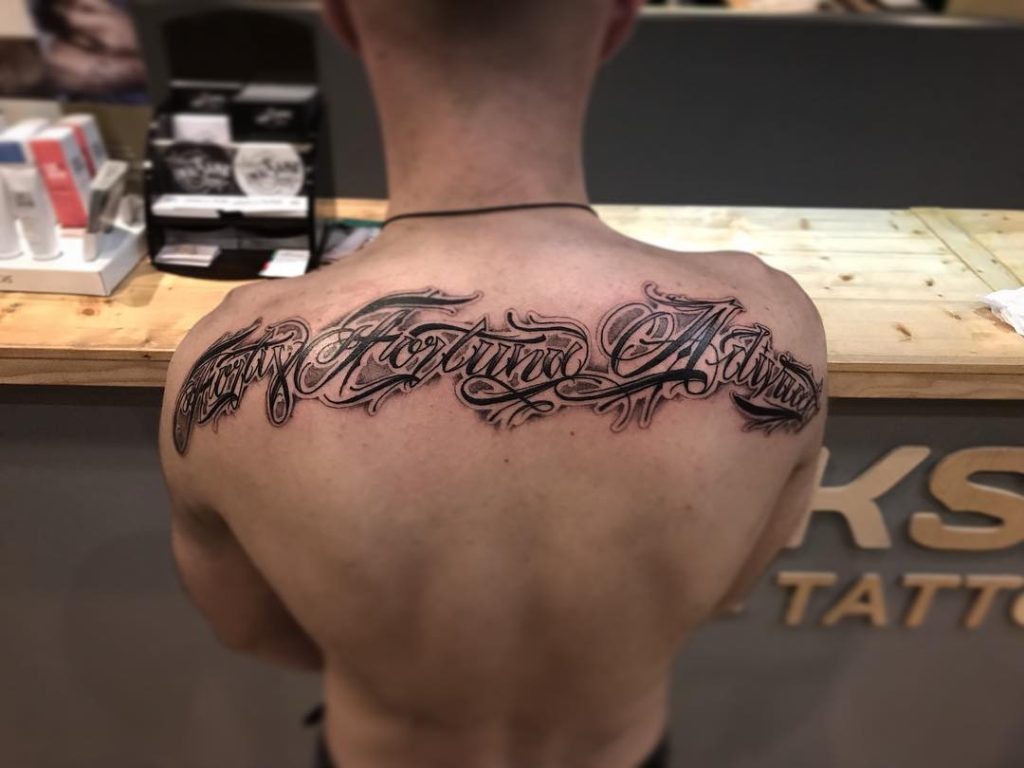 Elaborate Back Script Tattoo Design