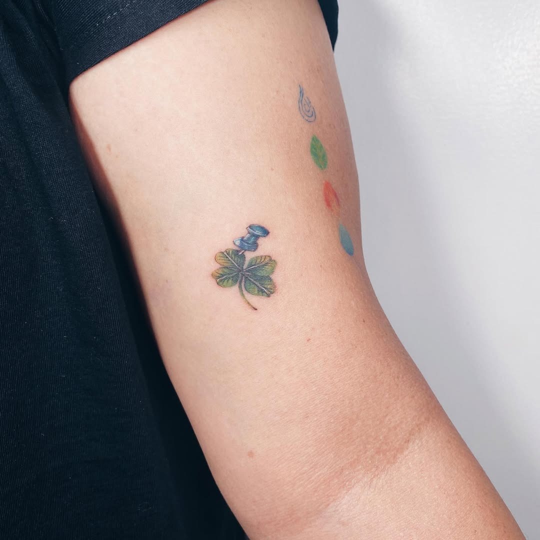 Charming four leaf clover tattoo with a bird Tattoo Design