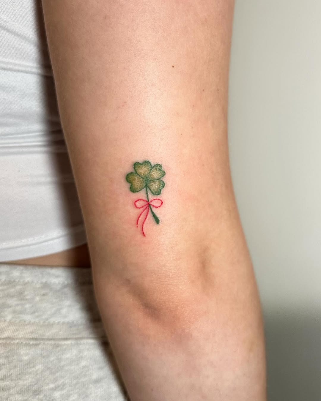 Charming four leaf clover tattoo with pink ribbon Tattoo Design