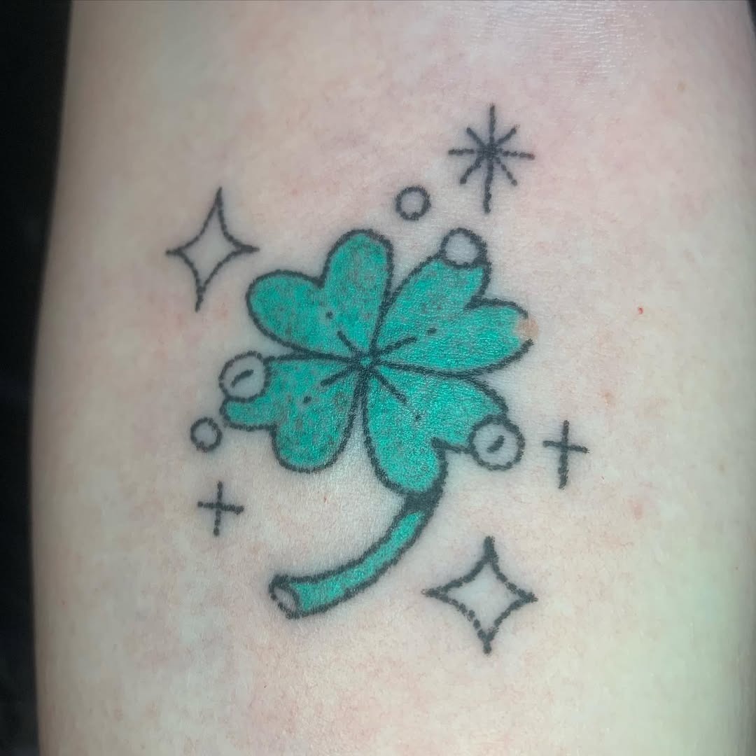Charming four-leaf clover tattoo with sparkles Tattoo Design