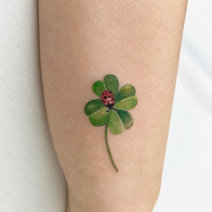 Charming four-leaf clover with ladybug detail Tattoo Design