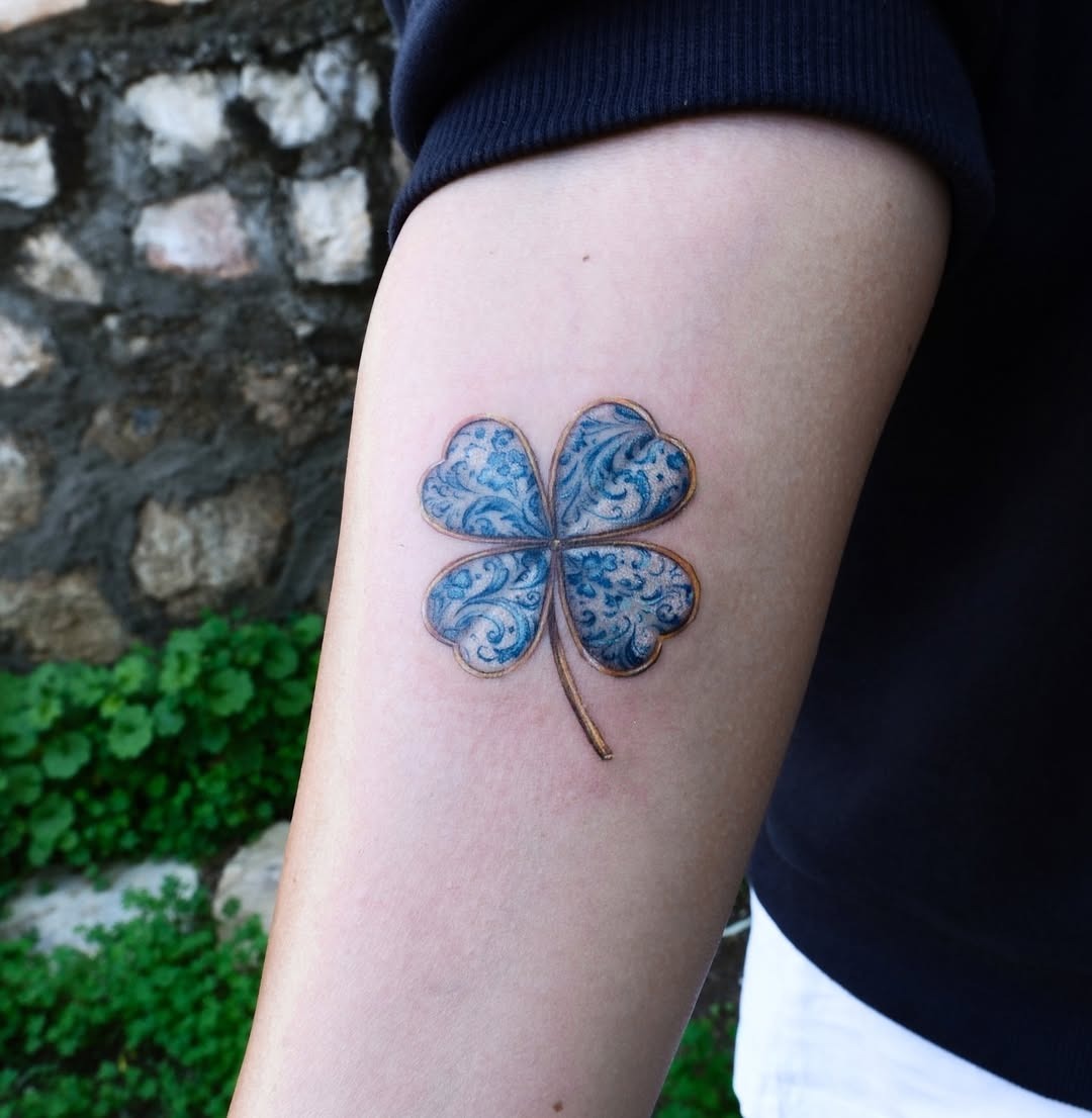 Elegant blue four-leaf clover tattoo design Tattoo Design