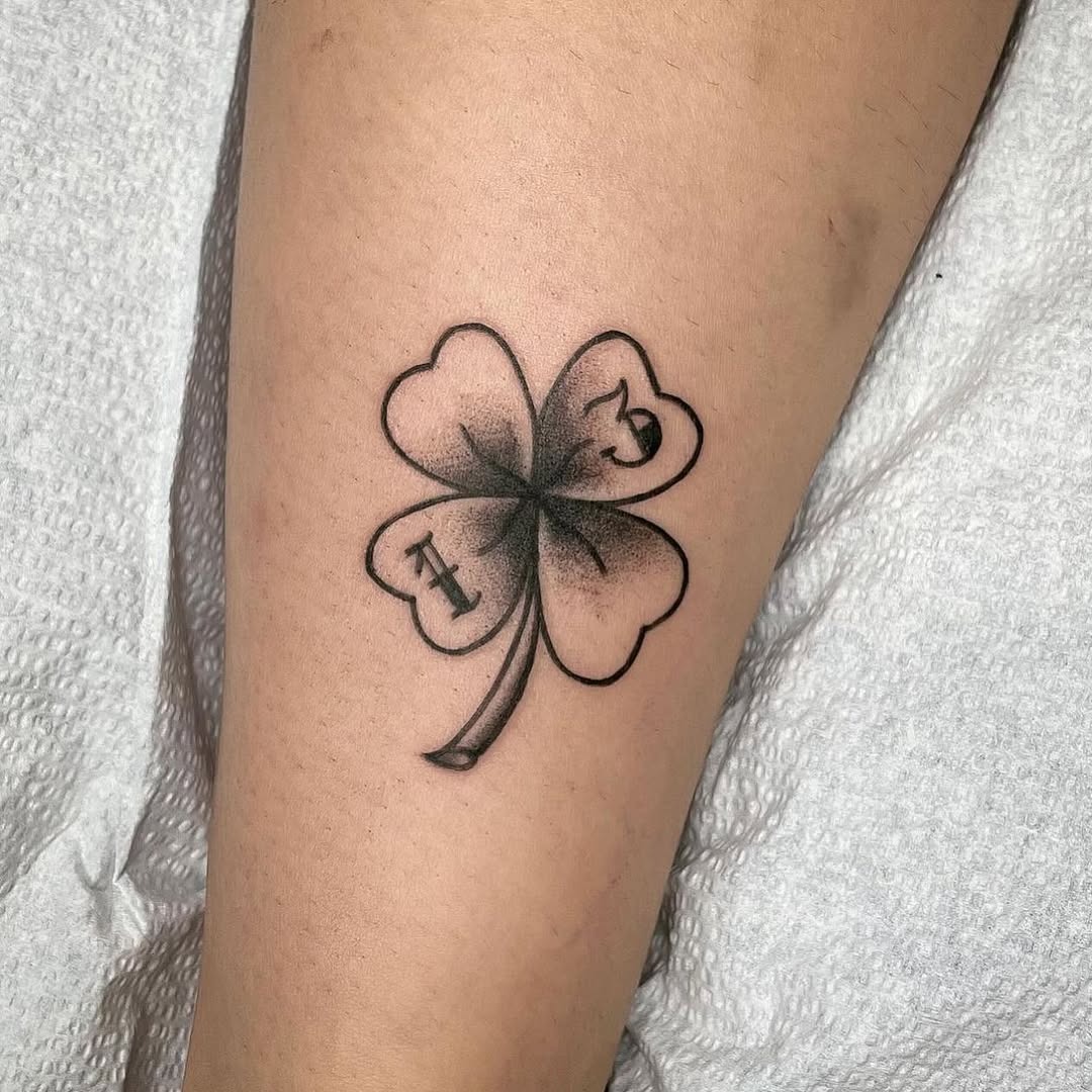 Elegant four-leaf clover tattoo on skin Tattoo Design