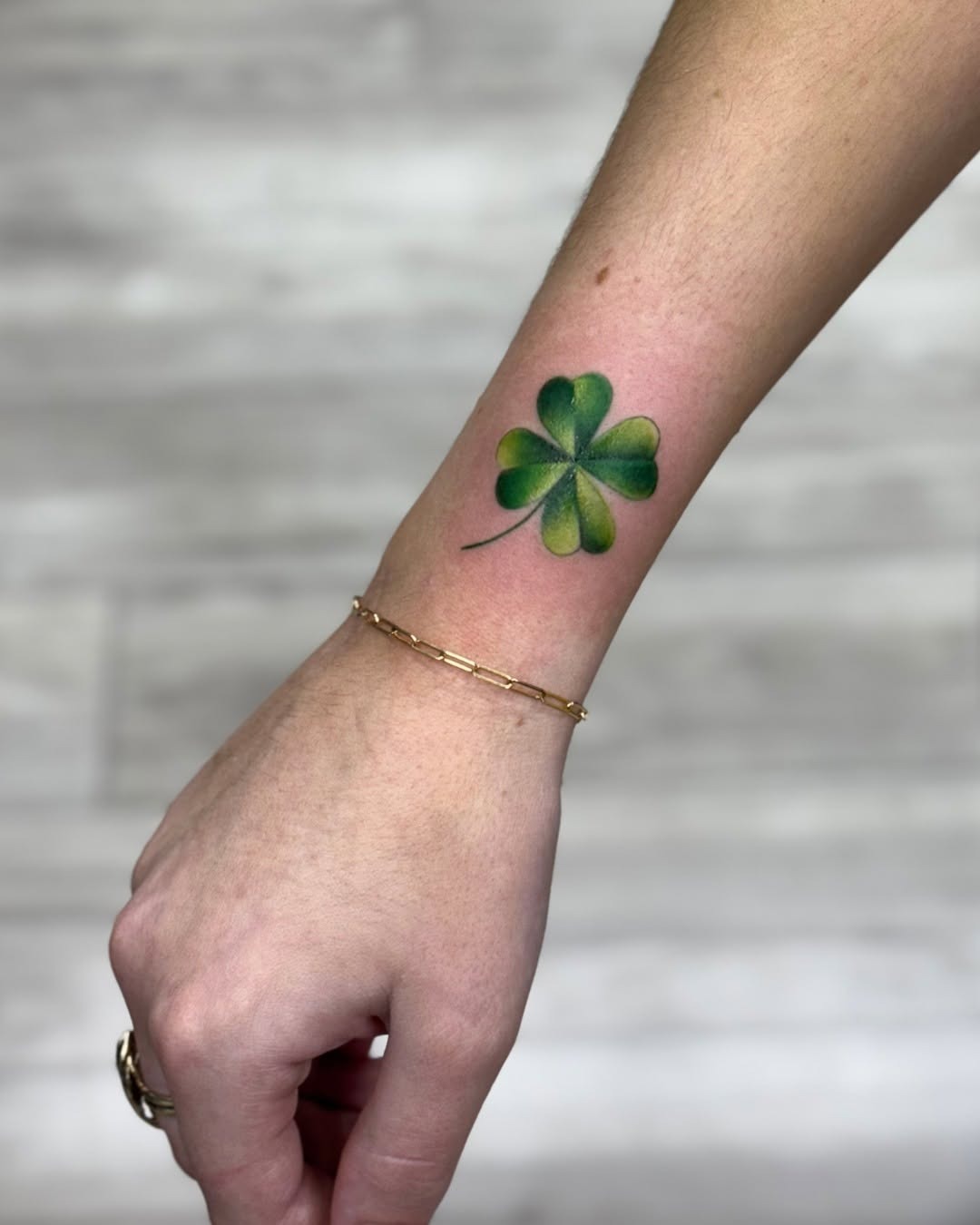 Elegant four-leaf clover tattoo on wrist Tattoo Design