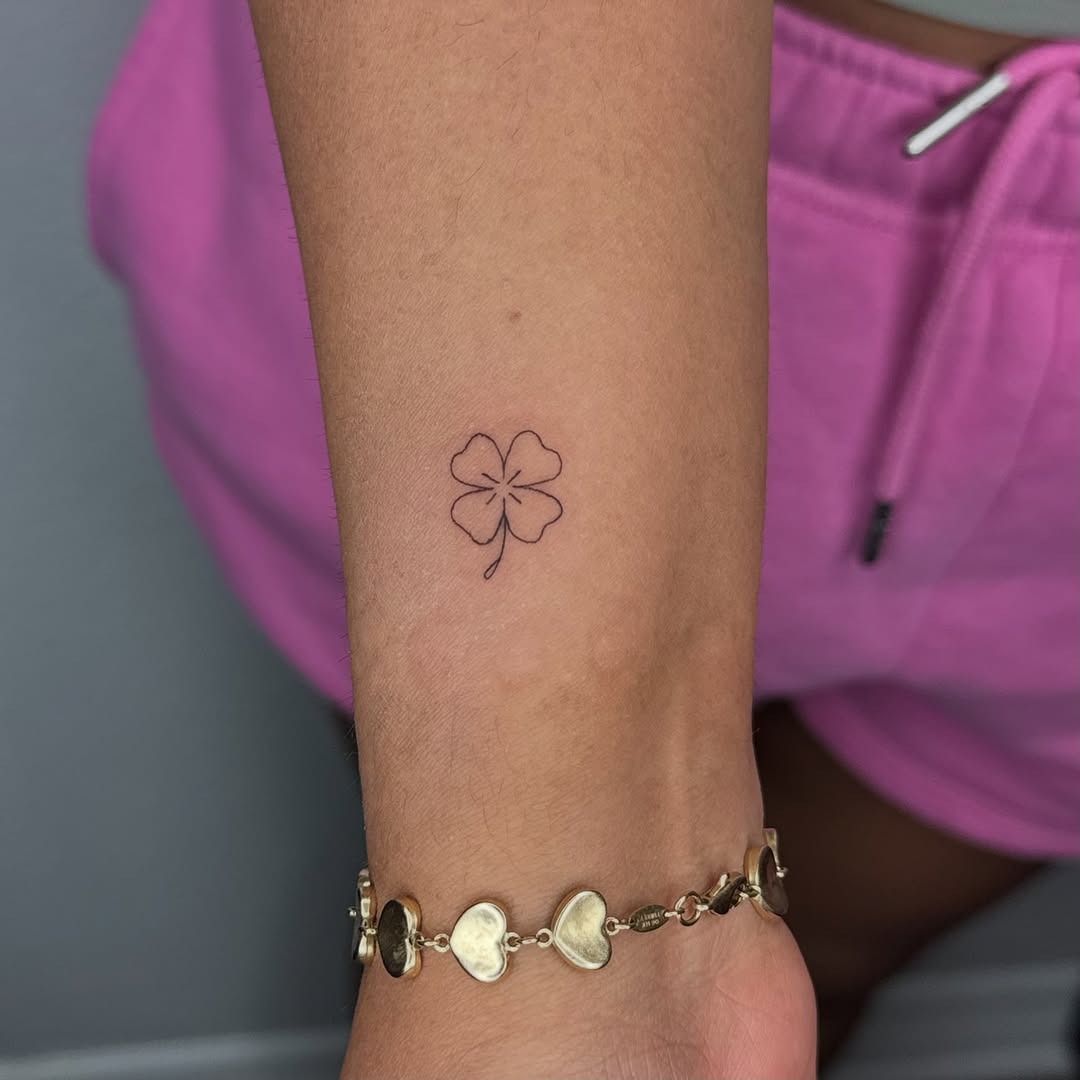 Minimalist four leaf clover tattoo on forearm Tattoo Design