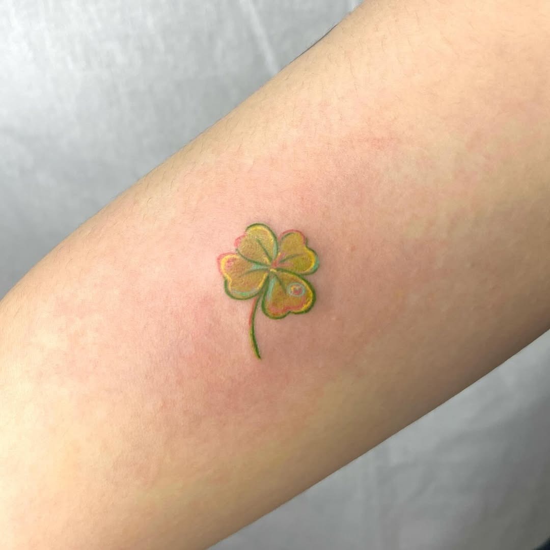 Vibrant four-leaf clover tattoo in pastels Tattoo Design