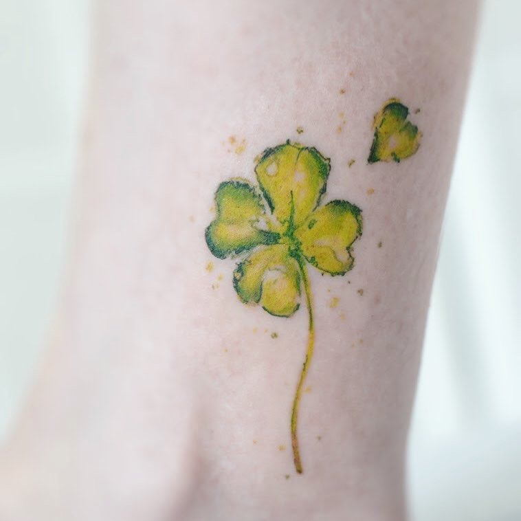 Vibrant watercolor four-leaf clover tattoo design Tattoo Design