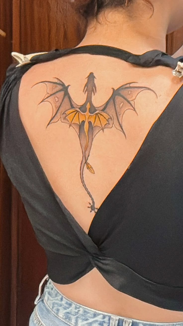 Small Back Dragon with Gold Wing Accent Tattoo Design