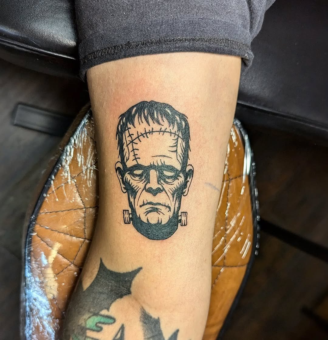 Stylized Frankenstein's Monster Tattoo on Leg Tattoo Design