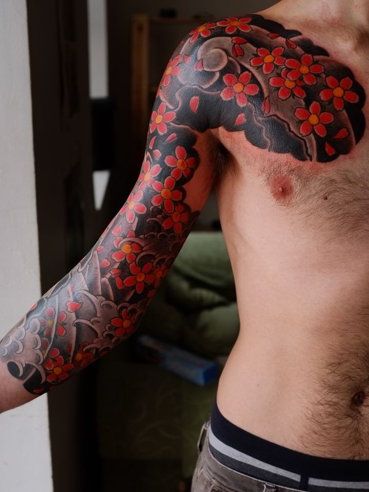 Drawing inspiration from traditional Japanese tattoo artistry, this sleeve features a dramatic mix of floral elements and clouds.