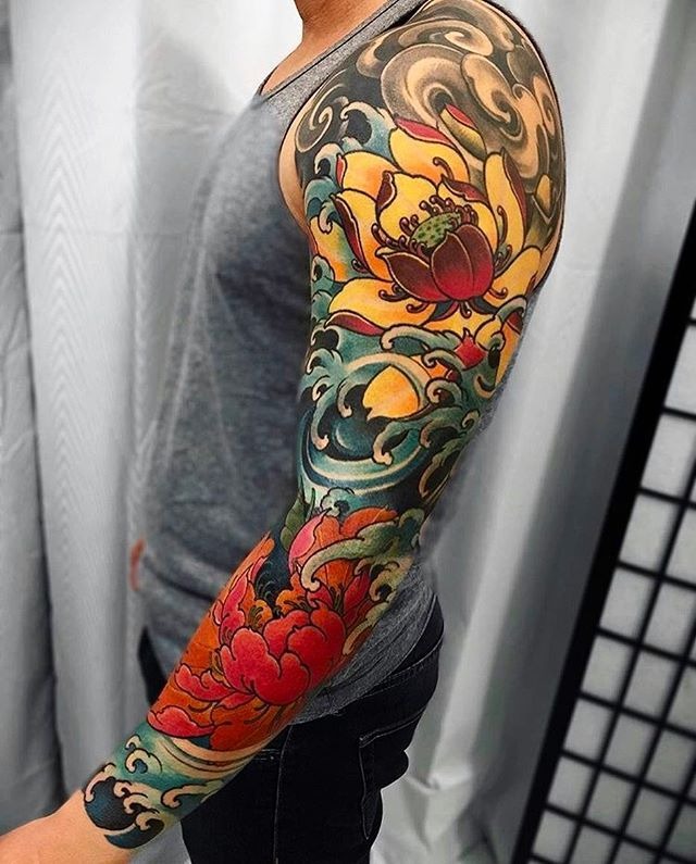 Vibrant Lotus and Japanese Wave Sleeve Tattoo Design