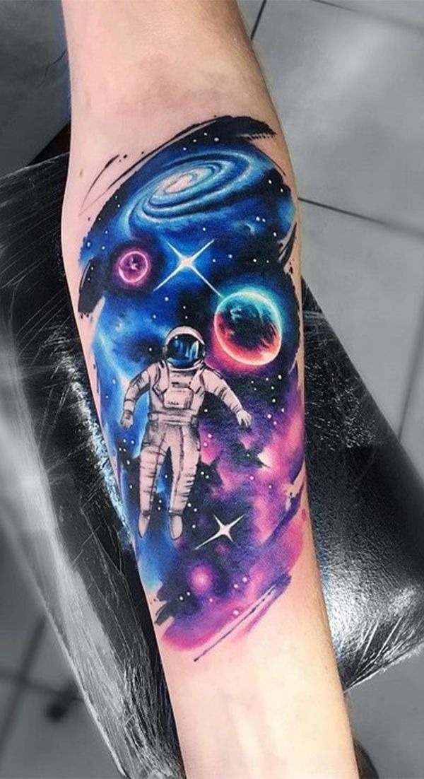 Astronaut Drifting Through a Neon Galaxy, a tattoo design rendered in bold for the arm.