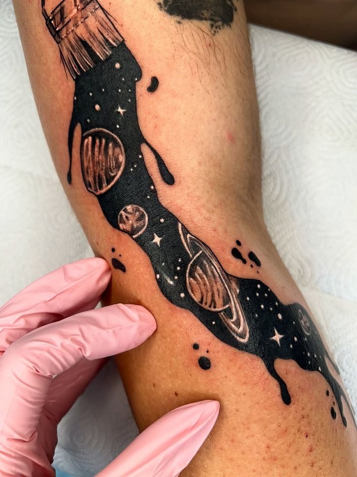 Black Drip Space Tattoo, a tattoo design rendered in delicate fine-line.