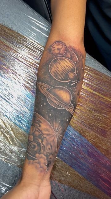 Sepia Planetary Arm Piece, a tattoo design rendered in clean detailed linework.