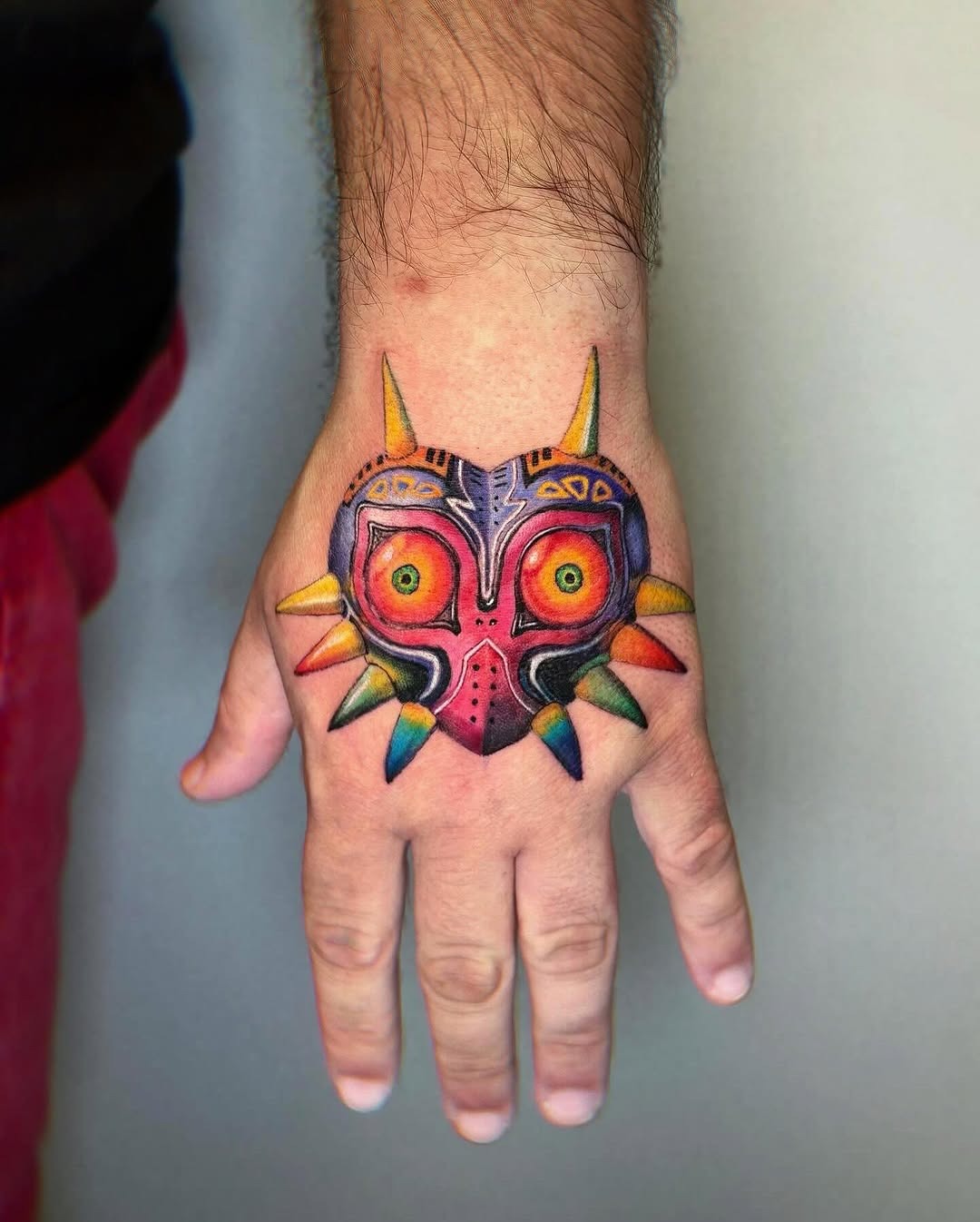 Vibrant Majora's Mask Hand Tattoo Design Tattoo Design