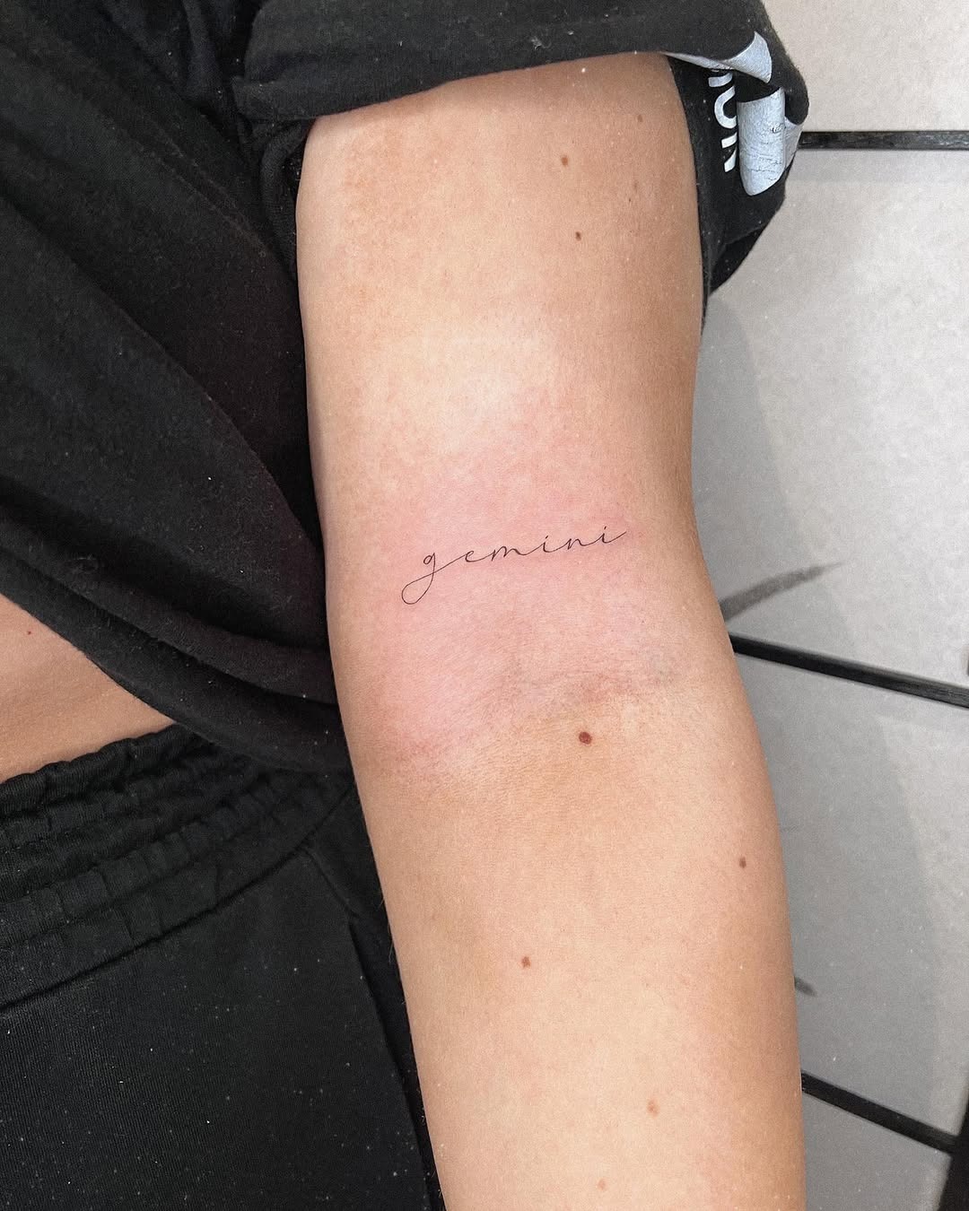 Elegant Gemini Script Tattoo on the Arm Tattoo Design