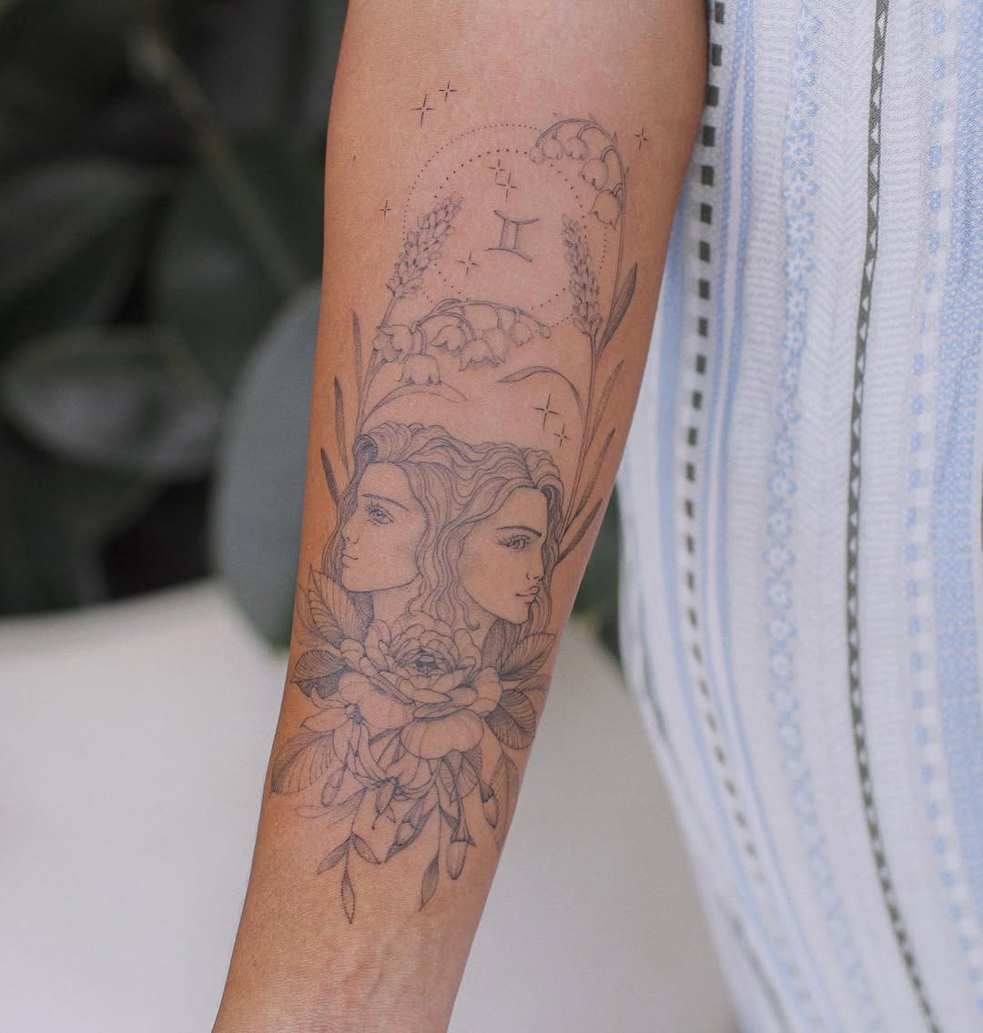 Elegant Gemini Tattoo with Floral Elements Tattoo Design