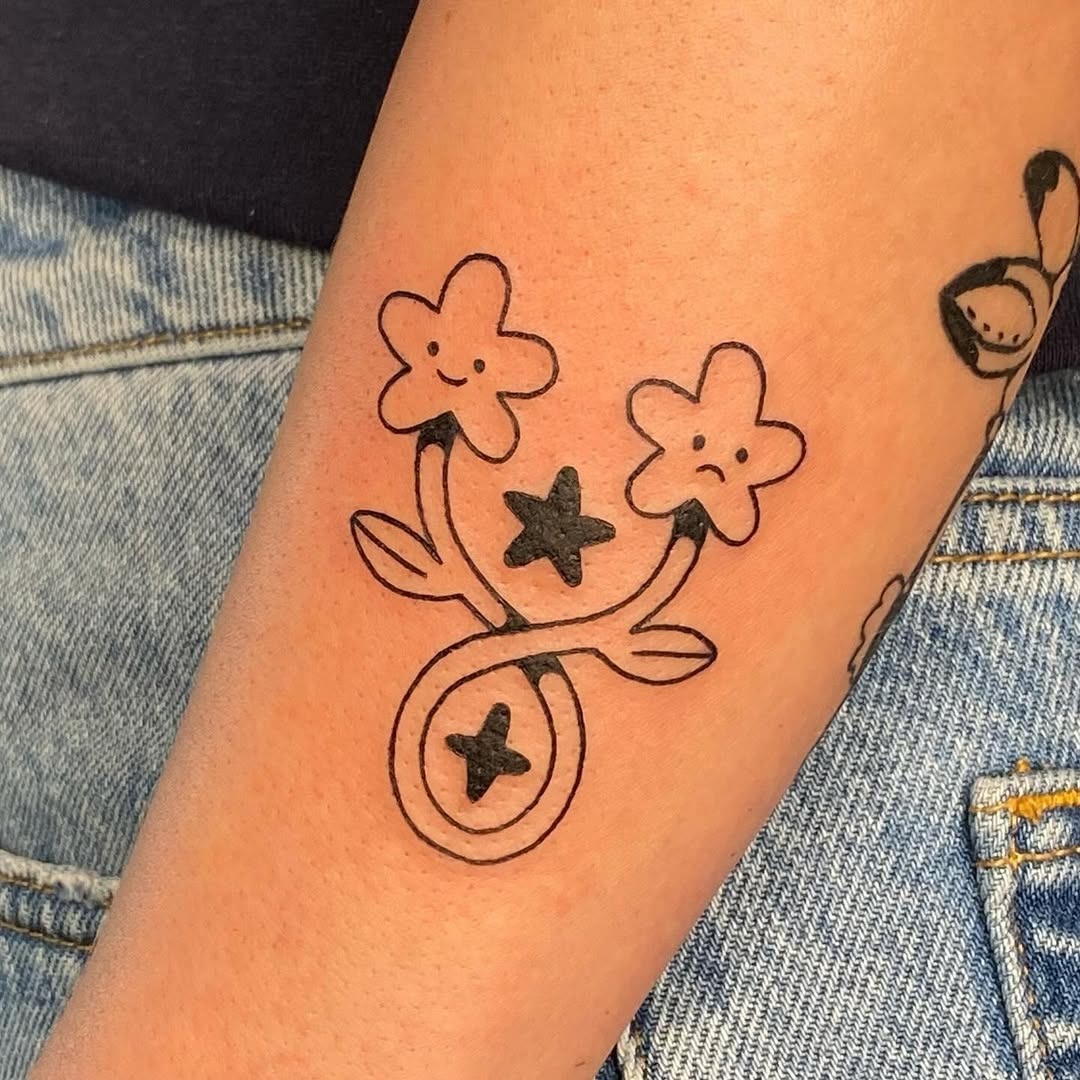Playful Gemini Tattoo with Floral Elements Tattoo Design
