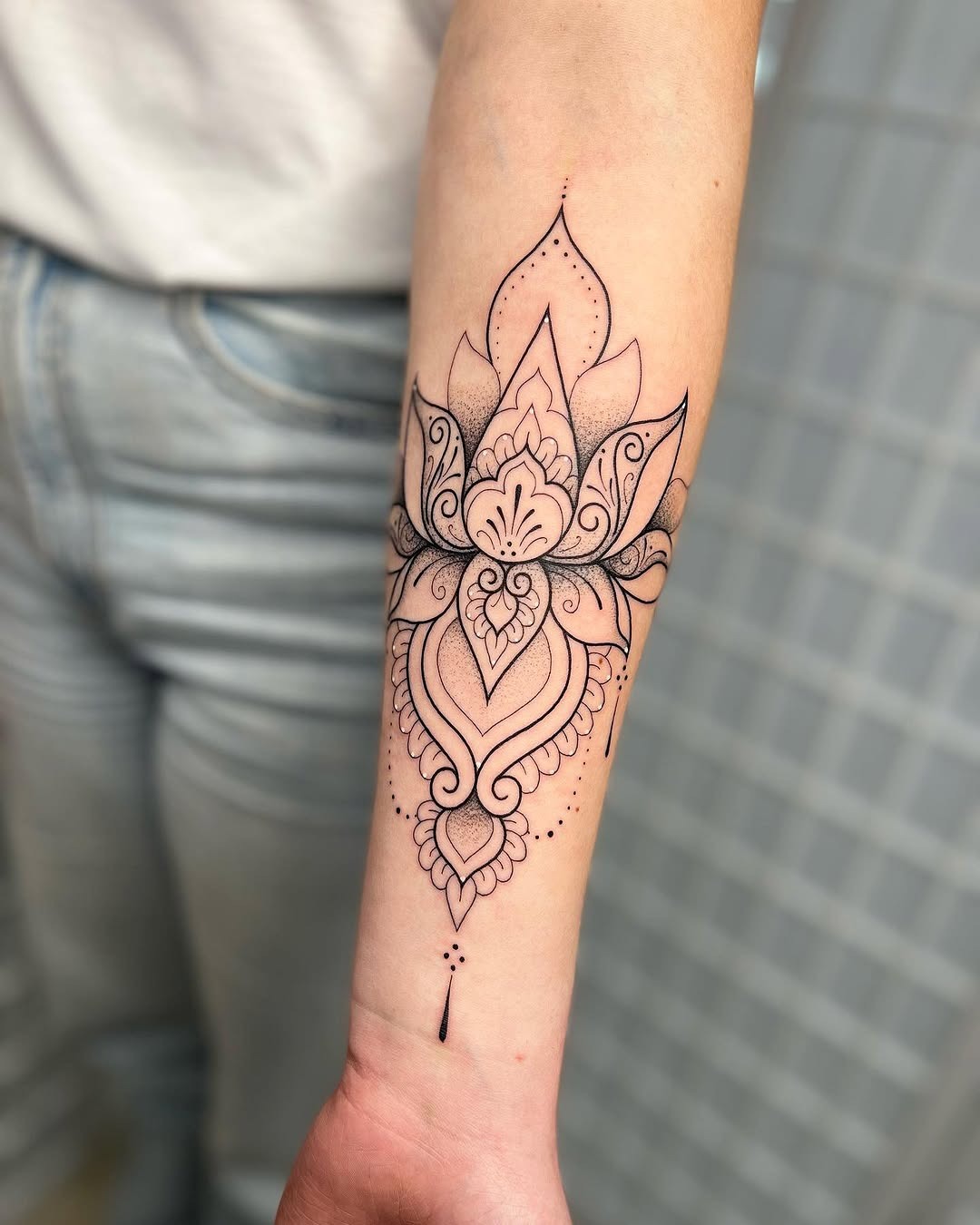 Elegant Mandala Tattoo Featuring a Lotus Flower Tattoo Design