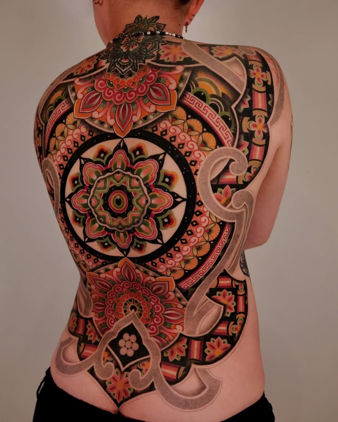 Intricate back mandala tattoo design in vibrant colors Tattoo Design