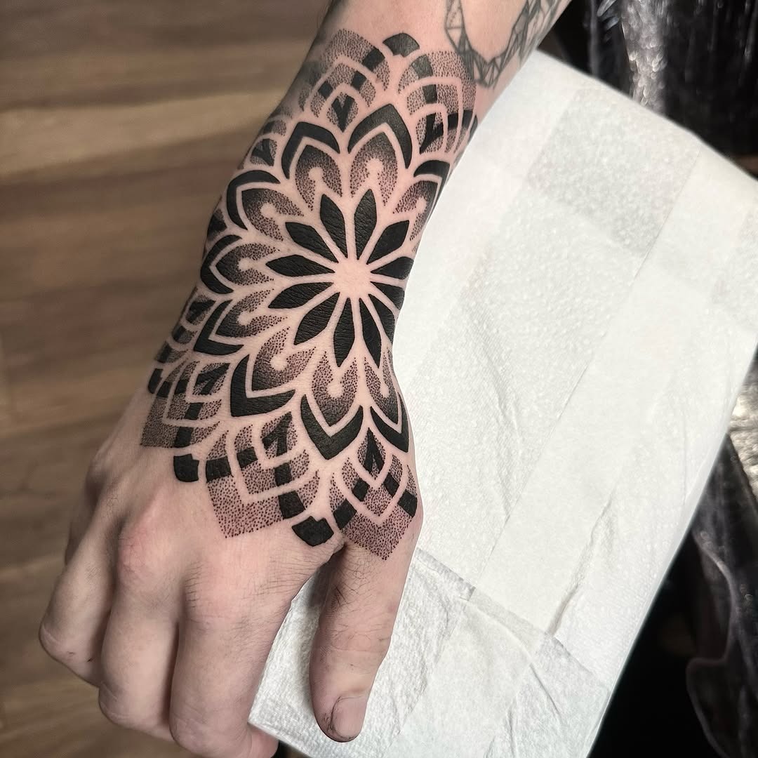 Intricate black ink mandala hand tattoo Tattoo Design