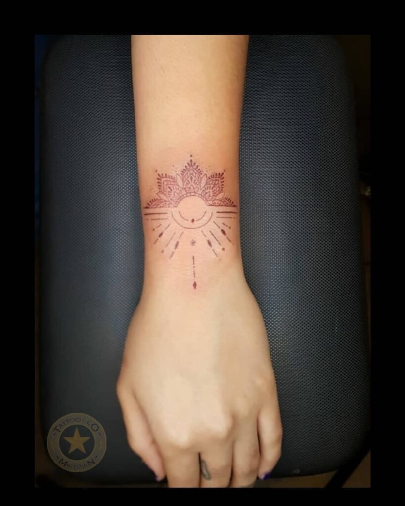 Minimalist Mandala Wrist Tattoo with Radiating Lines Tattoo Design