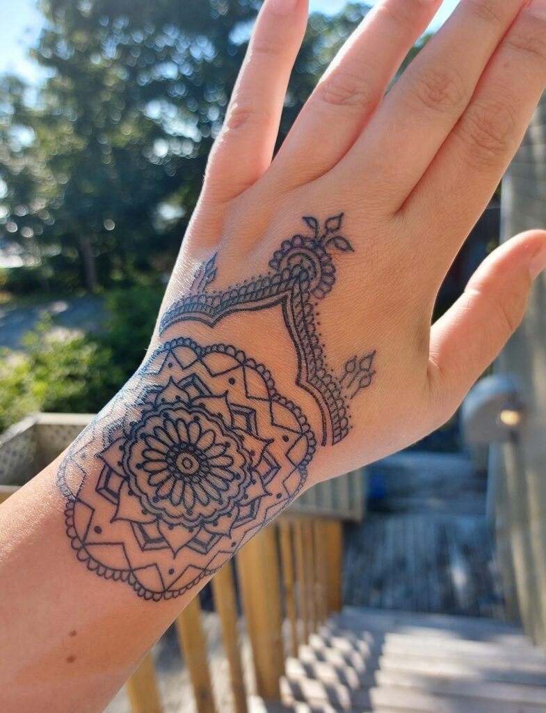 Ornamental Mandala Hand Tattoo with Lace Accents Tattoo Design