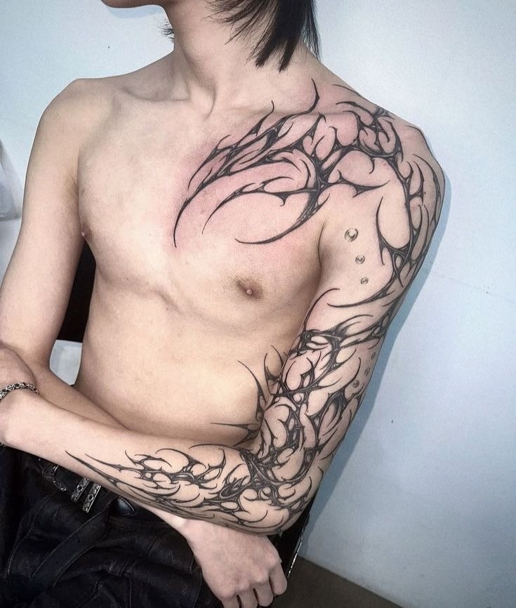 Abstract Chest and Sleeve Tribal Tattoo with Sharp Flow Tattoo Design