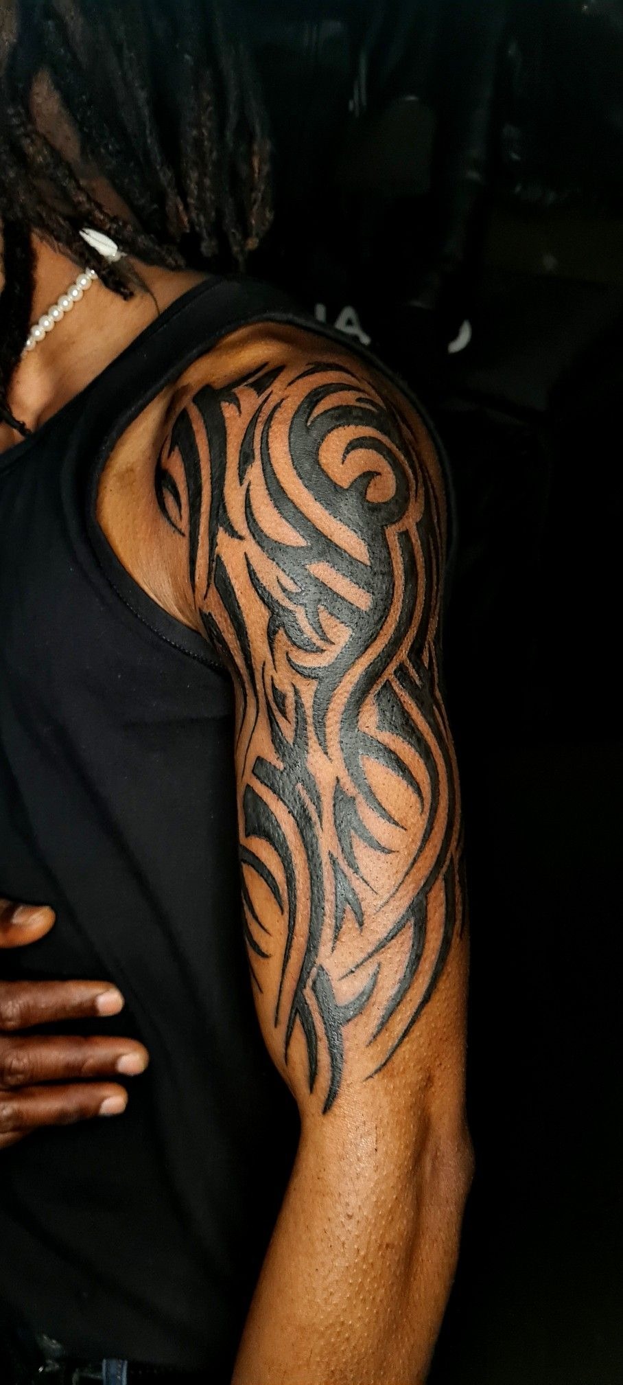 Black Tribal Shoulder Tattoo with Flowing Sleeve Movement Tattoo Design