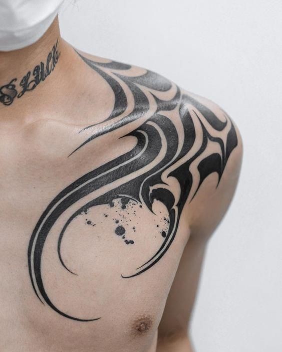 Chest and Shoulder Tribal Tattoo with Dark Sweeping Lines Tattoo Design
