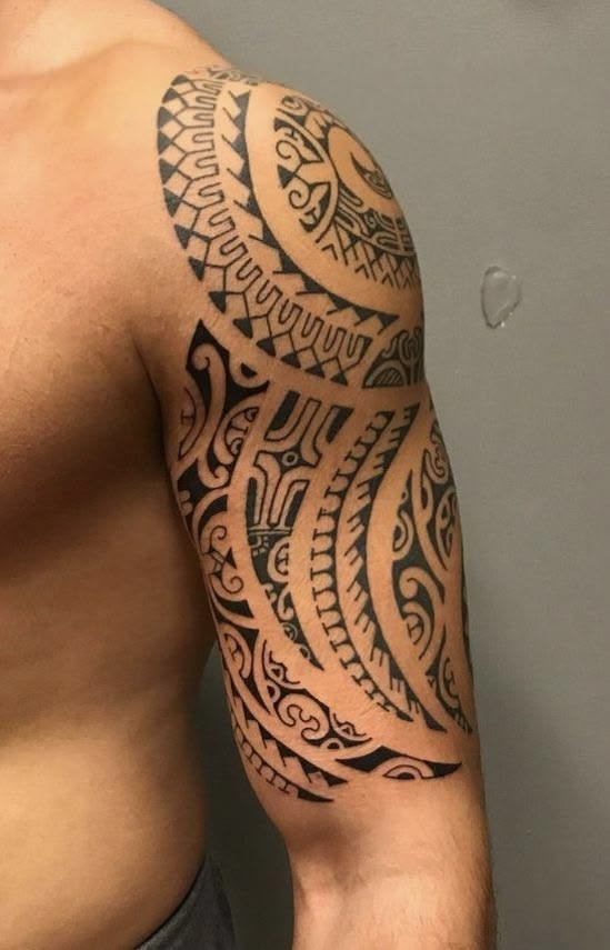Upper Arm Tribal Tattoo with Curved Symbolic Patterns Tattoo Design