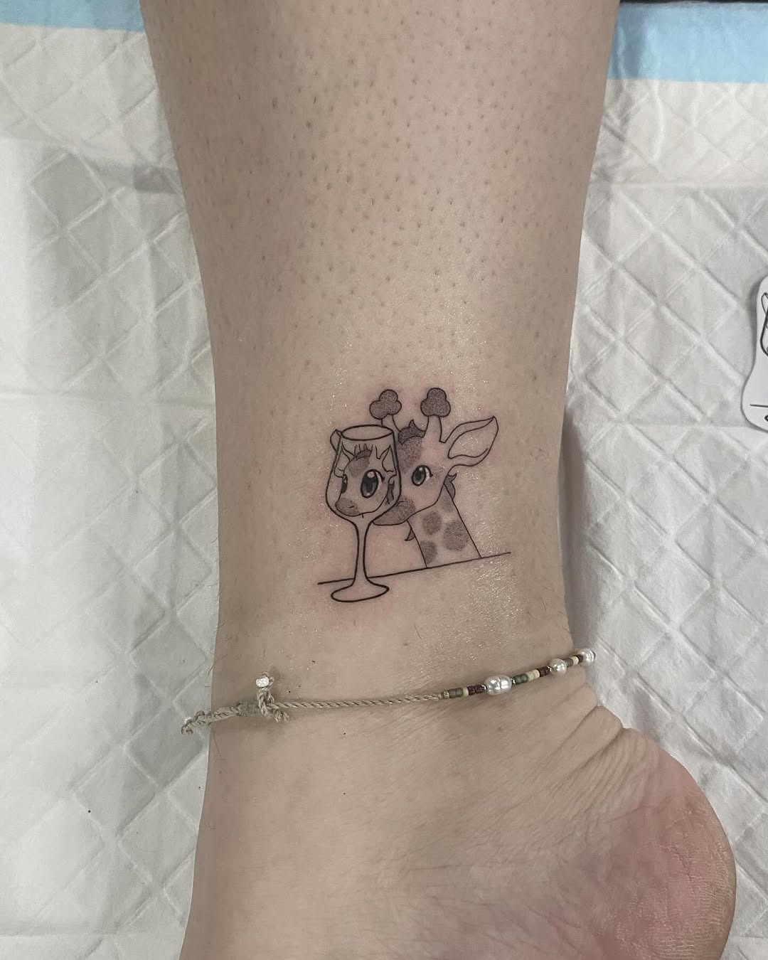 Adorable giraffe with whimsical drink tattoo Tattoo Design
