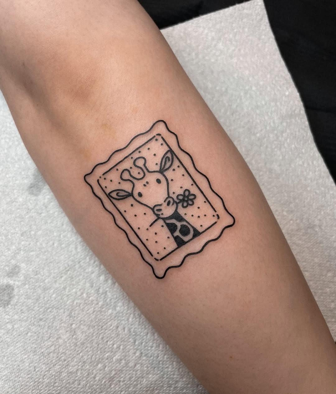 Charming framed giraffe tattoo in black outline Tattoo Design