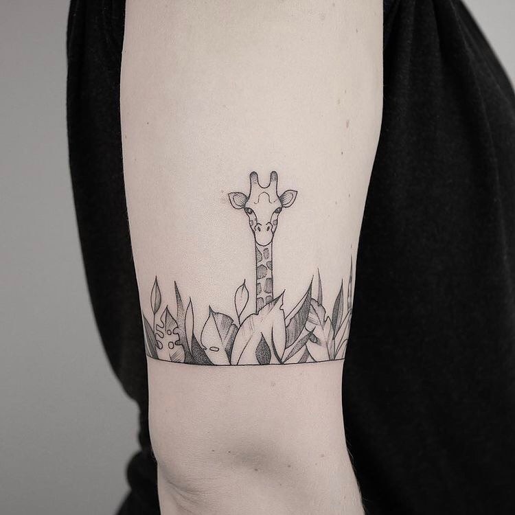 Charming giraffe tattoo peeking through foliage Tattoo Design