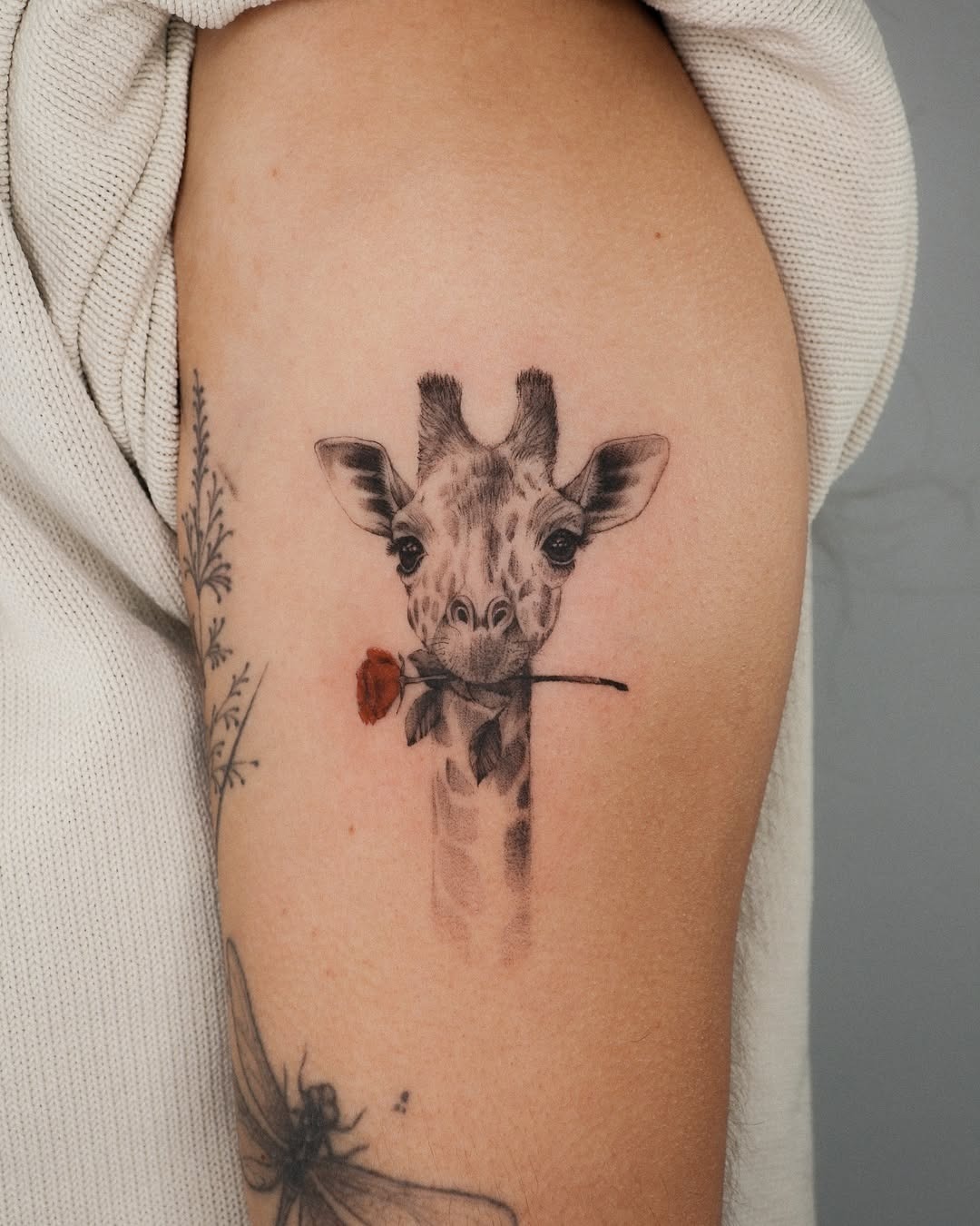 Charming giraffe tattoo with a playful touch Tattoo Design