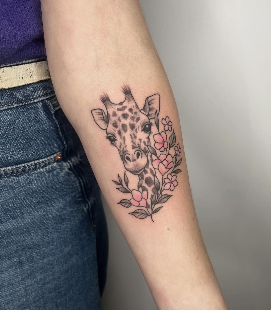 Charming giraffe tattoo with floral accents Tattoo Design