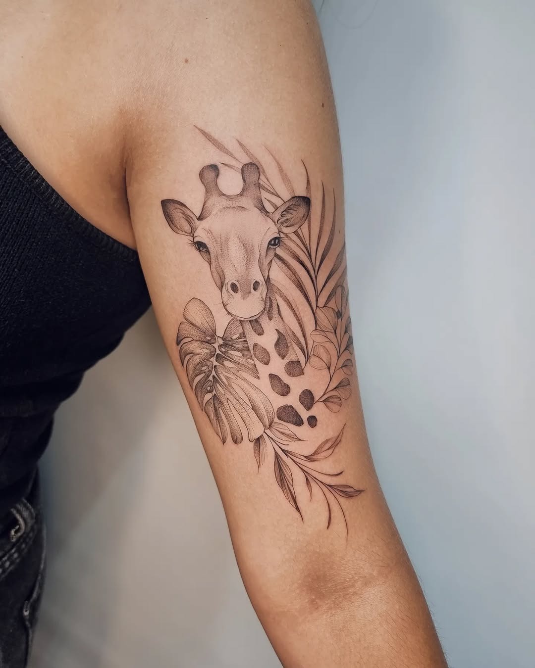 Elegant giraffe tattoo with lush tropical elements Tattoo Design