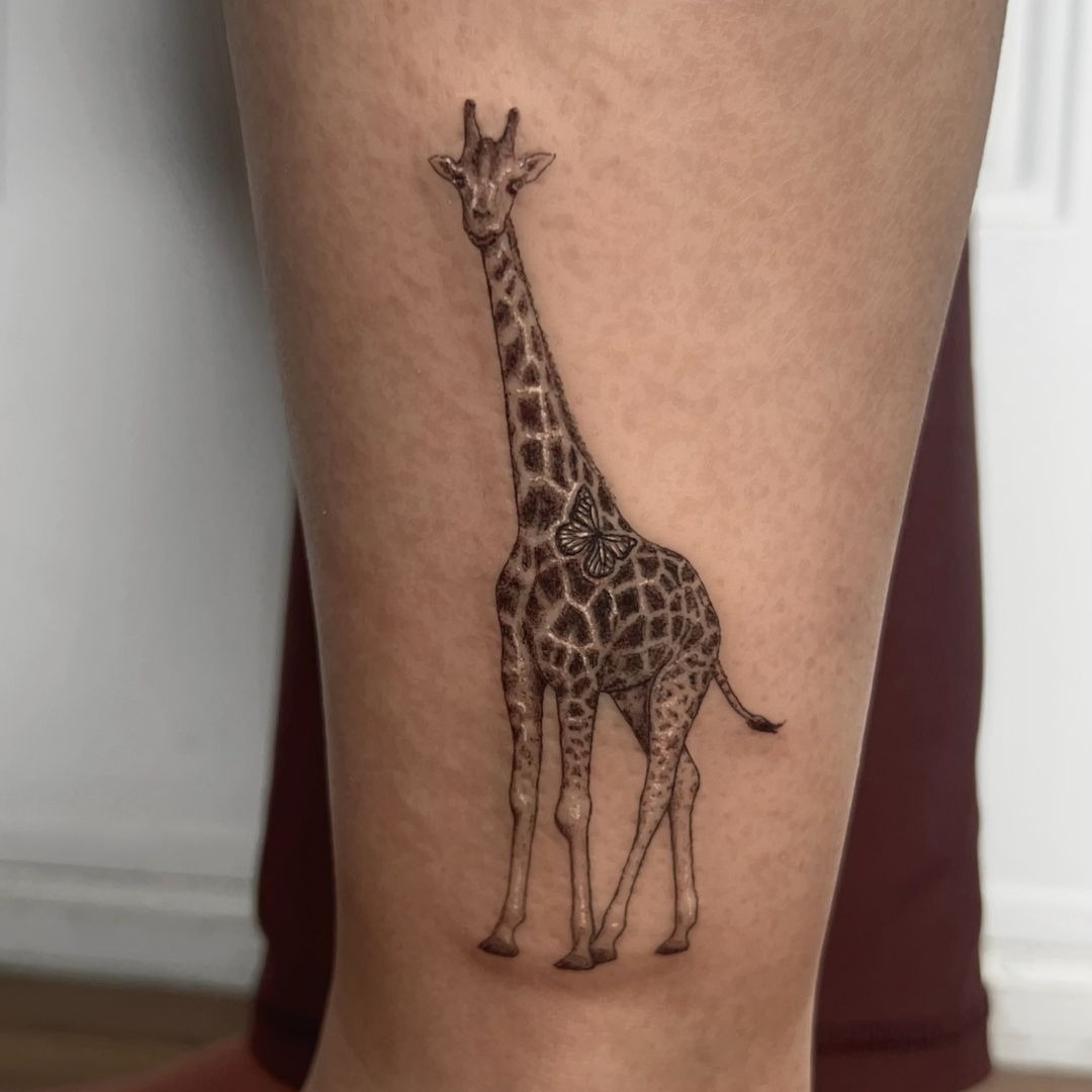 Intricate giraffe tattoo with butterfly embellishment Tattoo Design