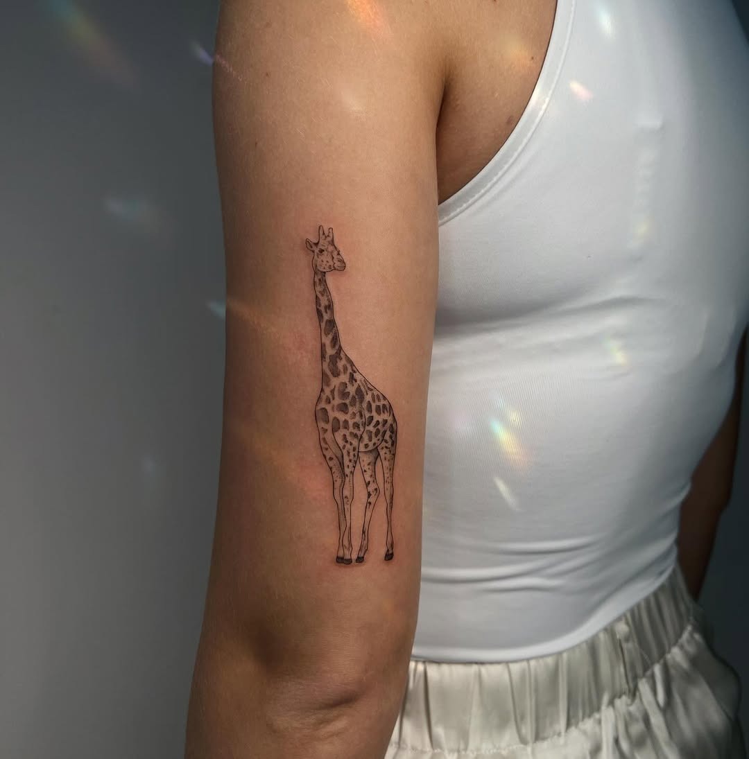 Minimalist giraffe tattoo on arm Tattoo Design