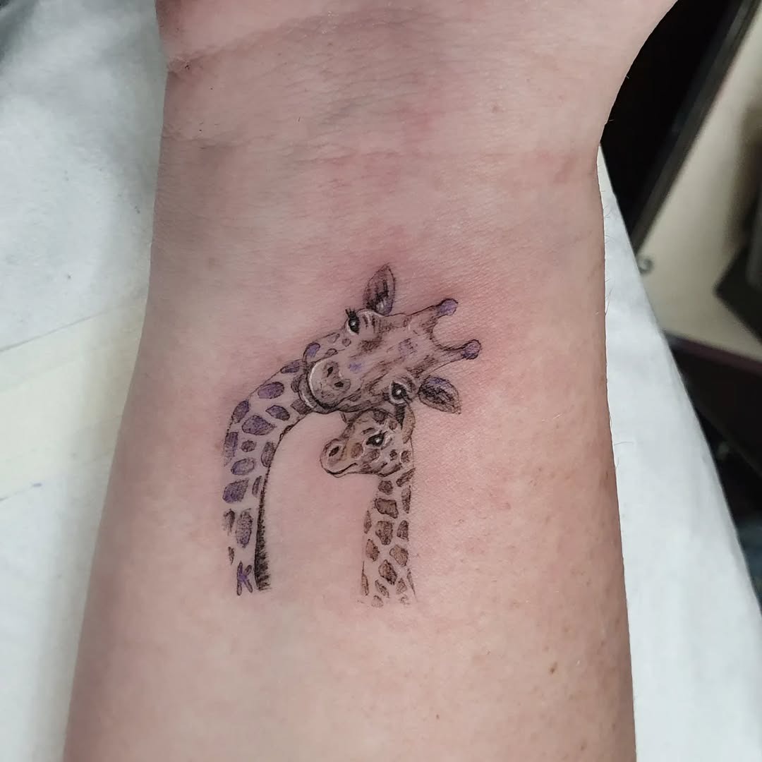 Playful Giraffe Tattoo Showcasing Connection Tattoo Design