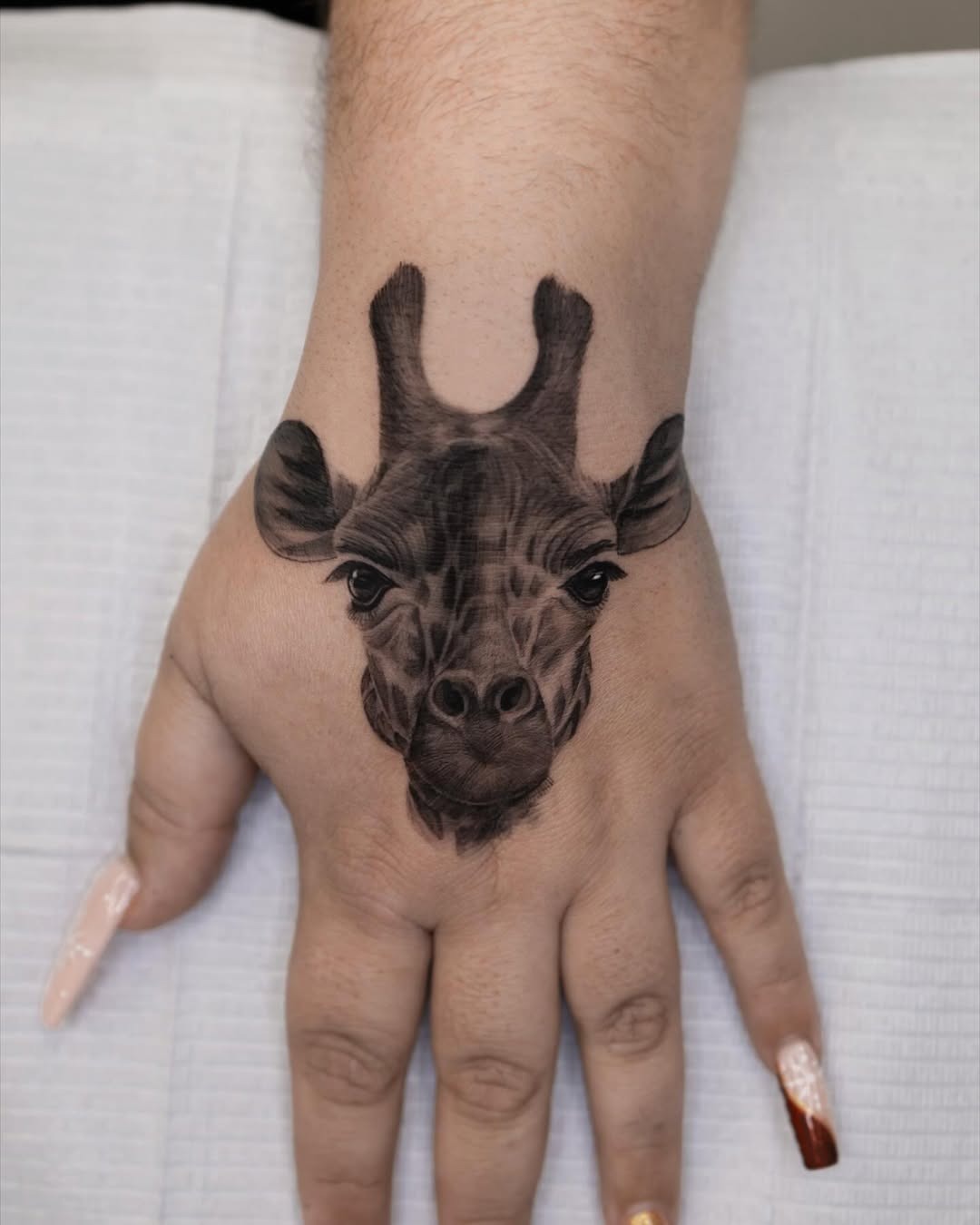 Realistic Giraffe Tattoo on the Hand Tattoo Design