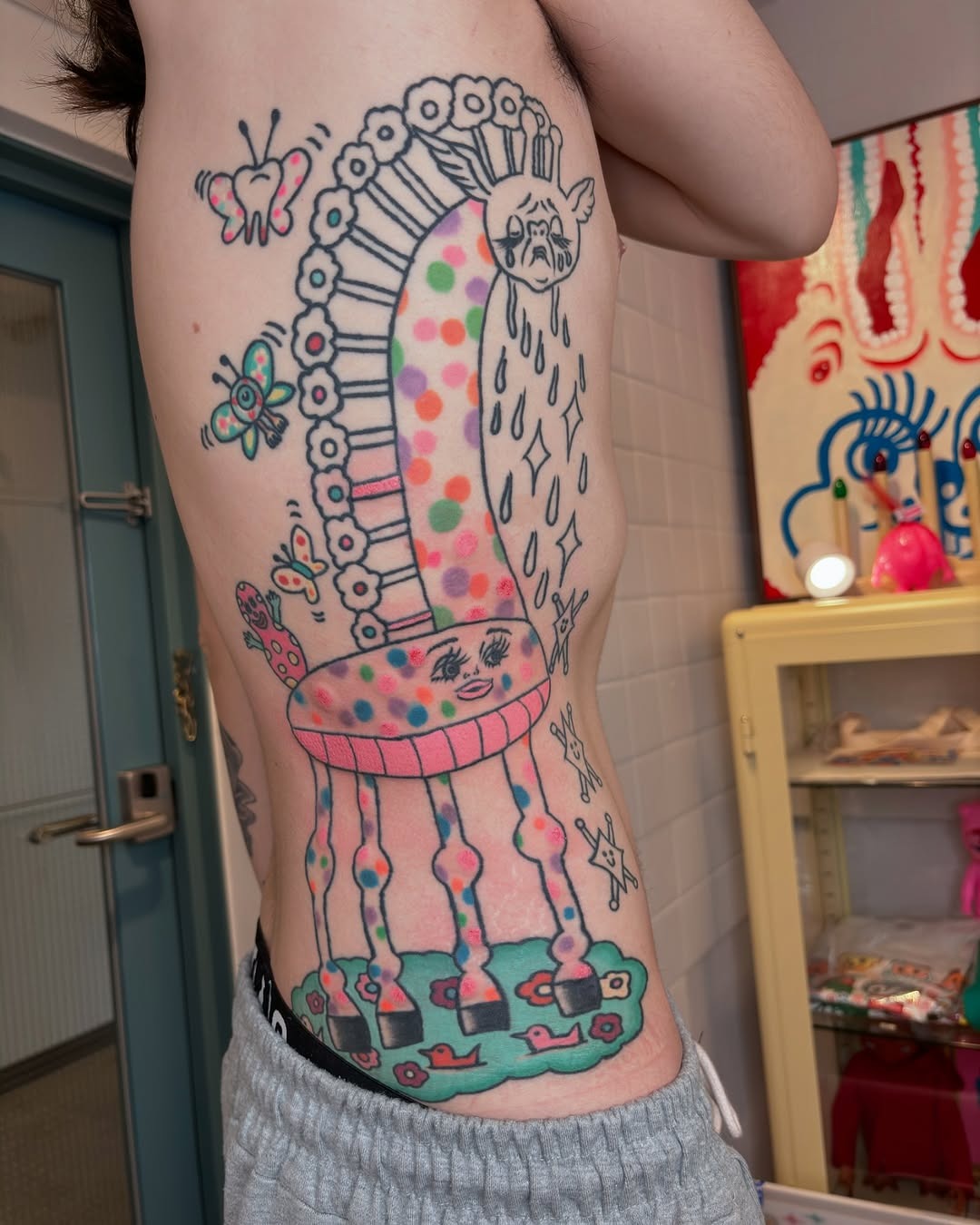 Whimsical Giraffe Tattoo with Playful Elements Tattoo Design