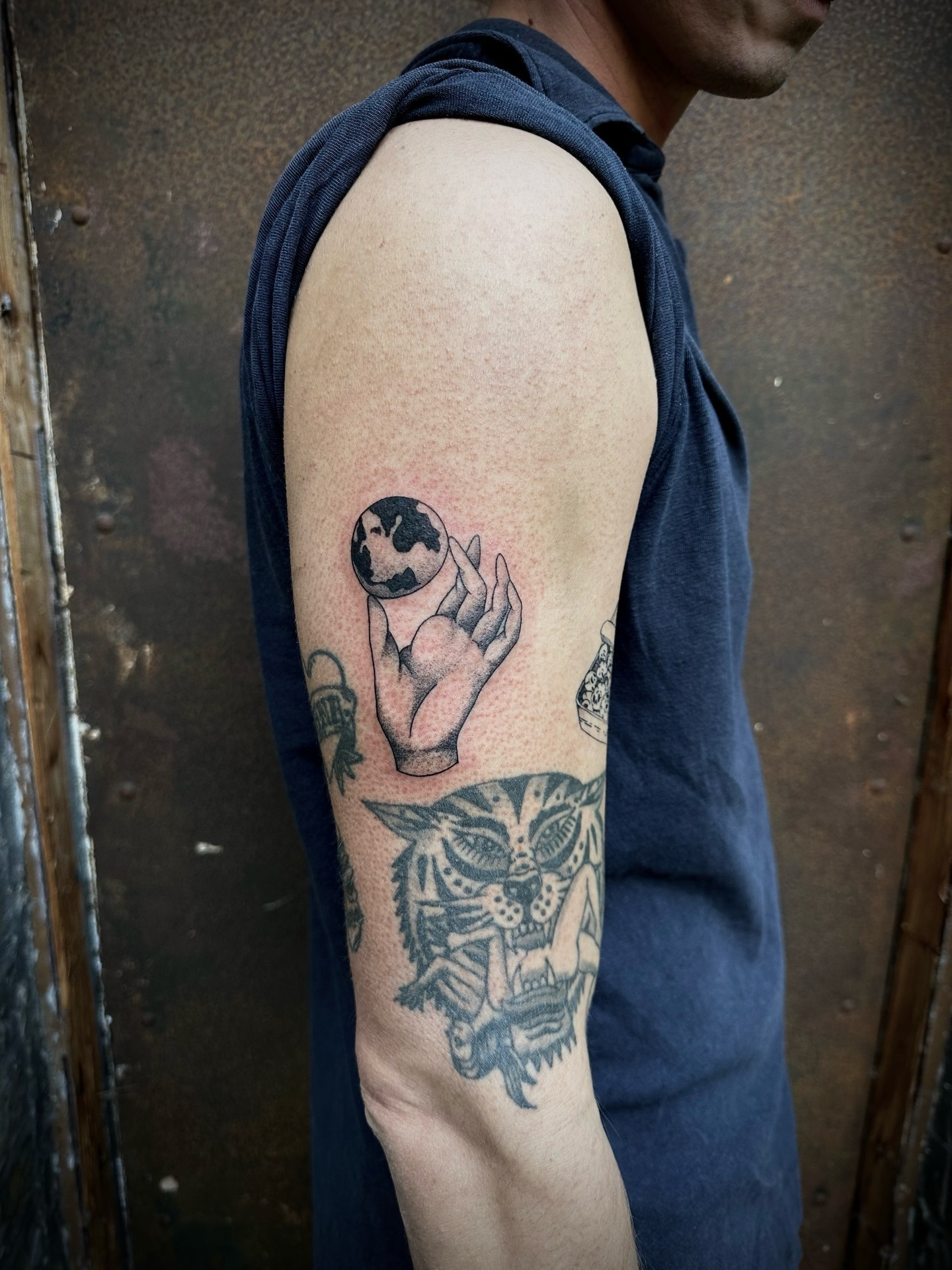 Artful globe tattoo capturing a delicate moment Tattoo Design