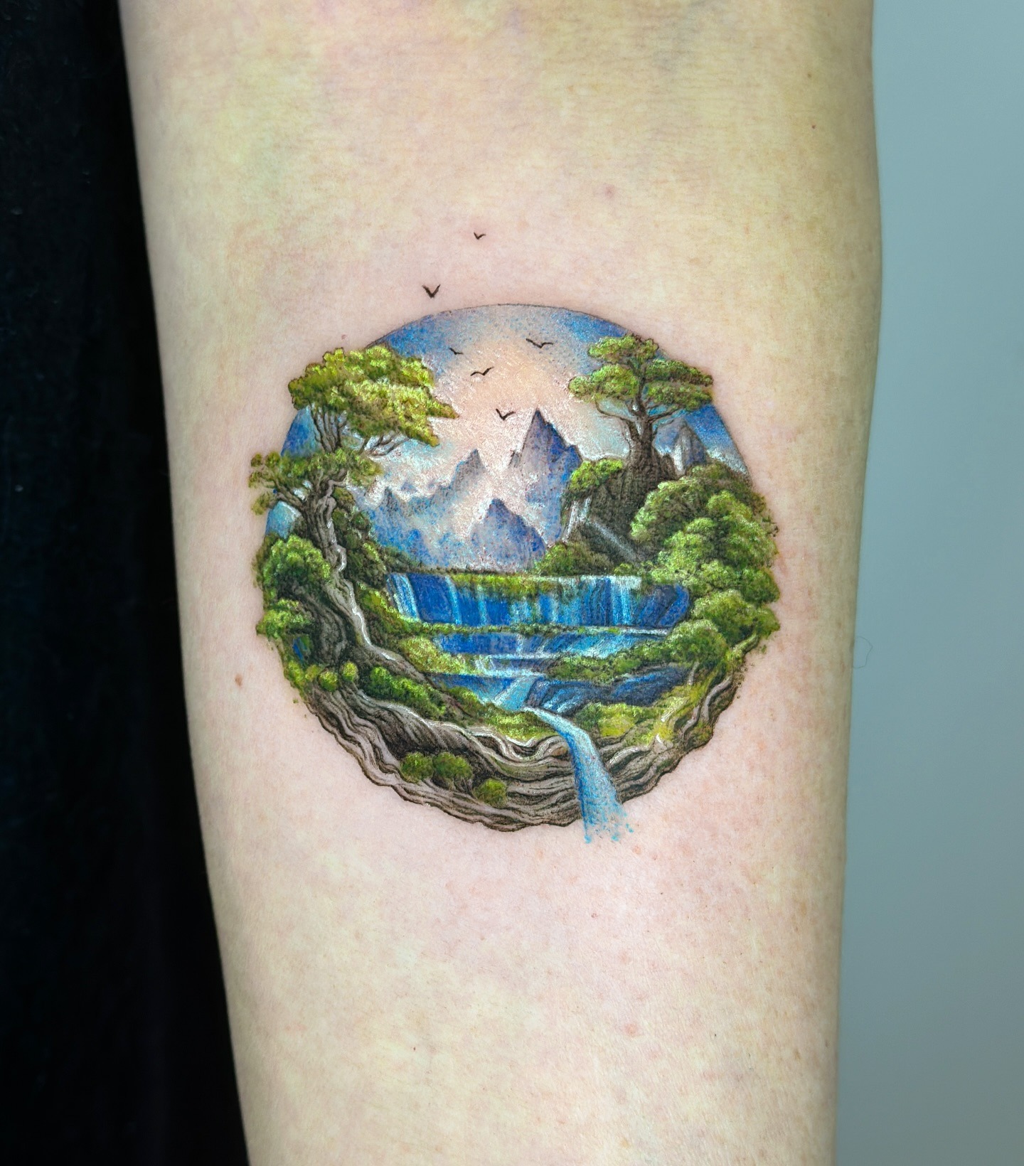 Breathtaking nature scene in a globe tattoo Tattoo Design