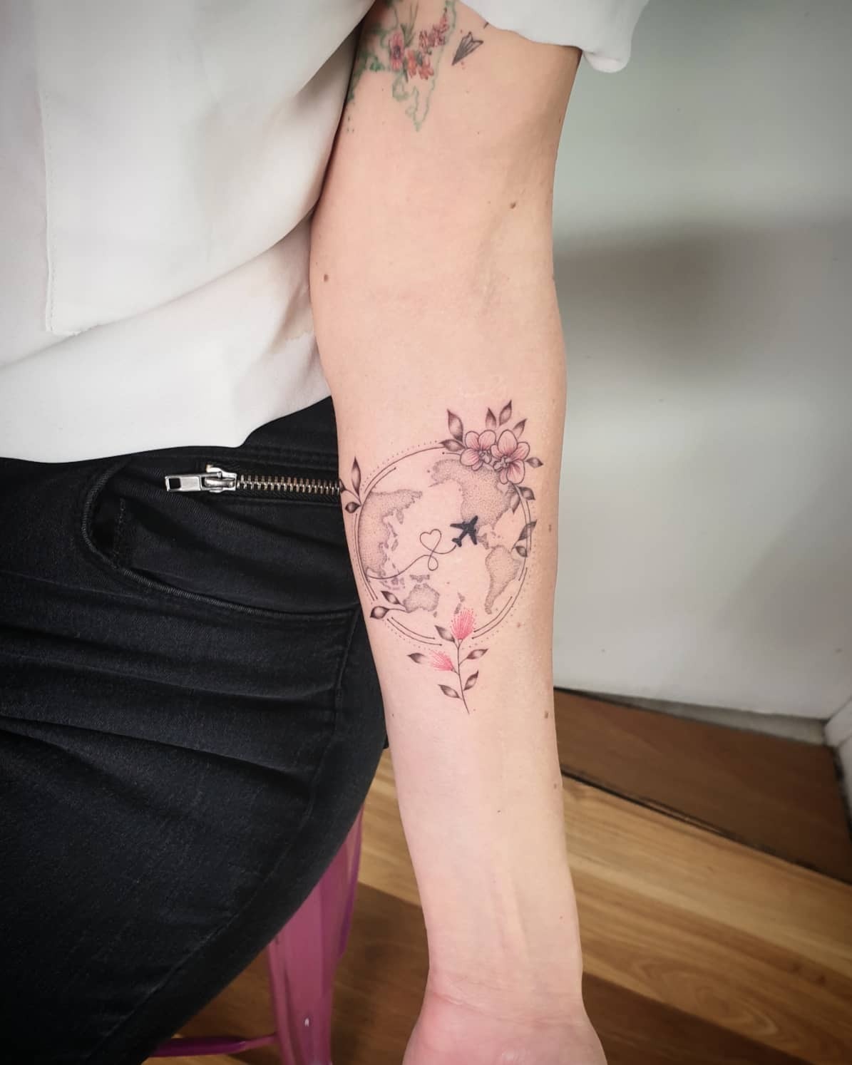 Delicate floral globe tattoo with travel vibes Tattoo Design