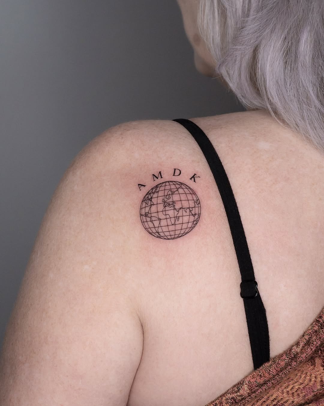 Elegant globe tattoo radiating wanderlust vibes Tattoo Design