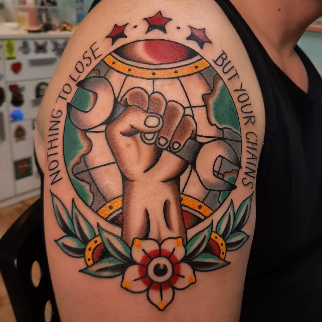 Empowering globe tattoo with a symbolic fist Tattoo Design