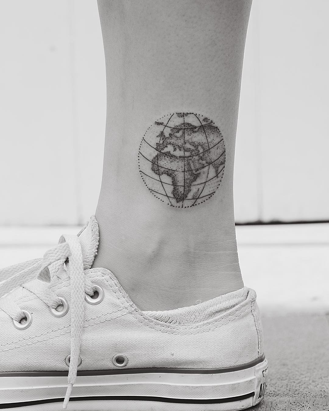 Minimalist globe tattoo on the ankle Tattoo Design