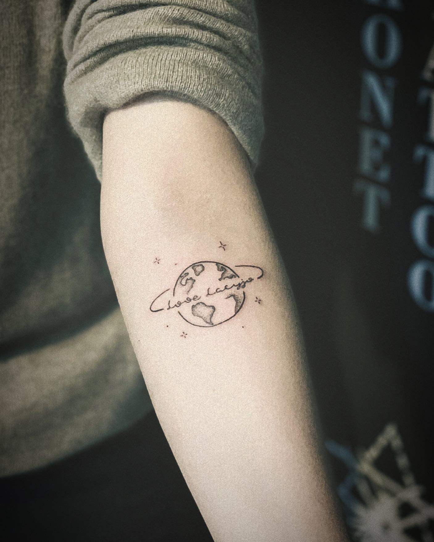 Minimalist globe tattoo with heart accents Tattoo Design