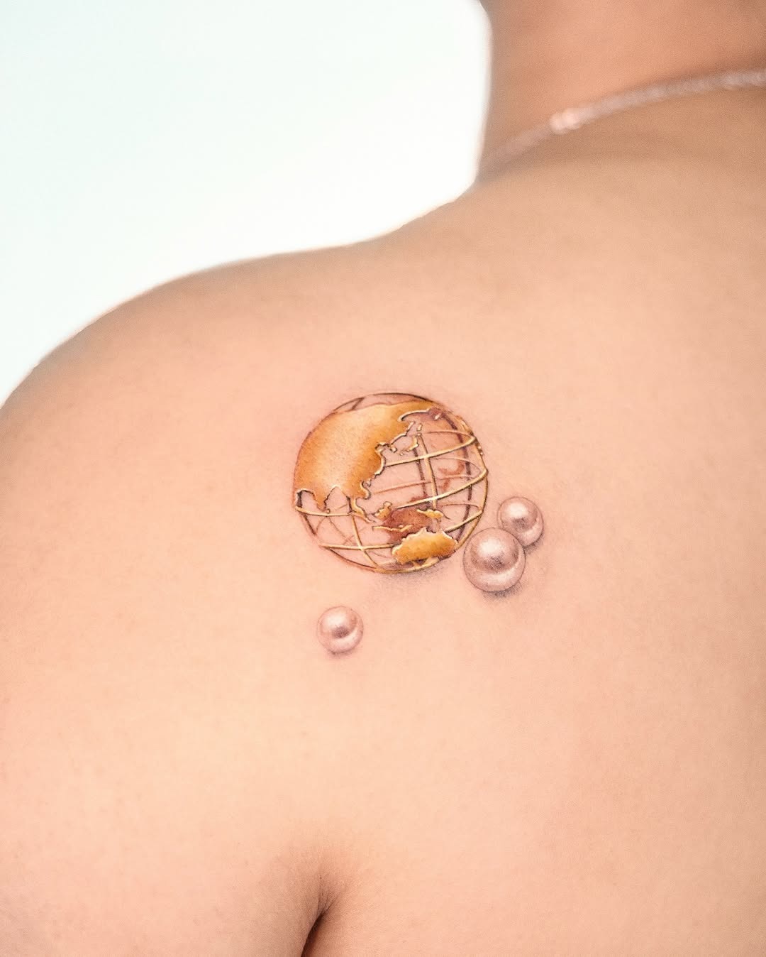 Stunning globe tattoo with elegant details Tattoo Design